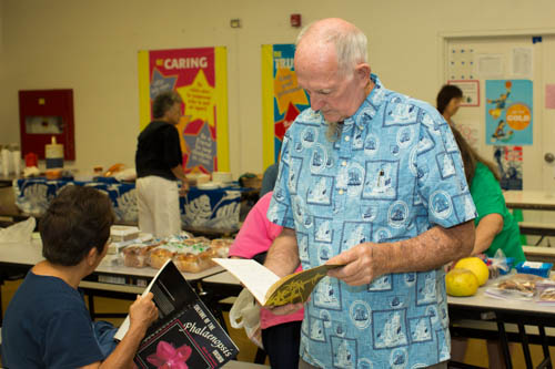 Andy Vilet inspects some of the orchid books that were available for bidding.